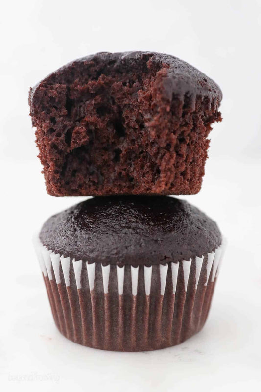 Freshly baked chocolate cupcake with a rich, moist chocolate muffin top and soft chocolate cake center.