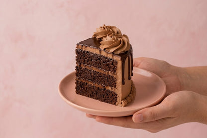 Detailed view of GUL chocolate cake with glossy ganache, chocolate drip and hand-piped mocha frosting