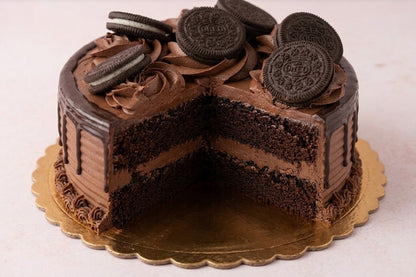 Top view of Oreo chocolate drip cake decorated with chocolate rosettes and sandwich cookies